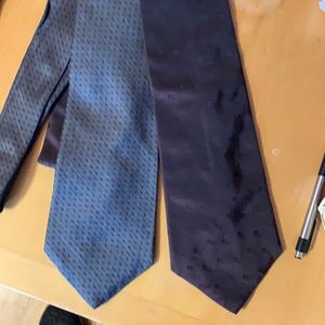 Two DKNY ties.  One dark maroon. The other dark silver gray.